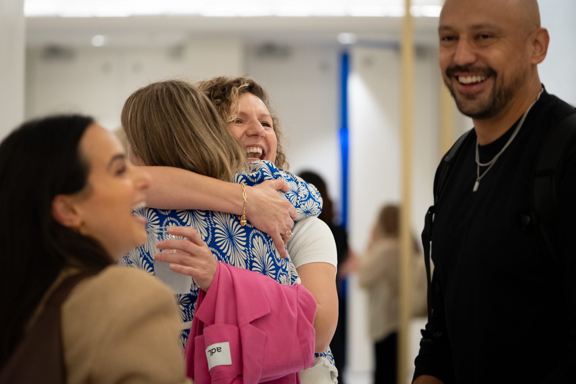 Community members embracing at a meetup